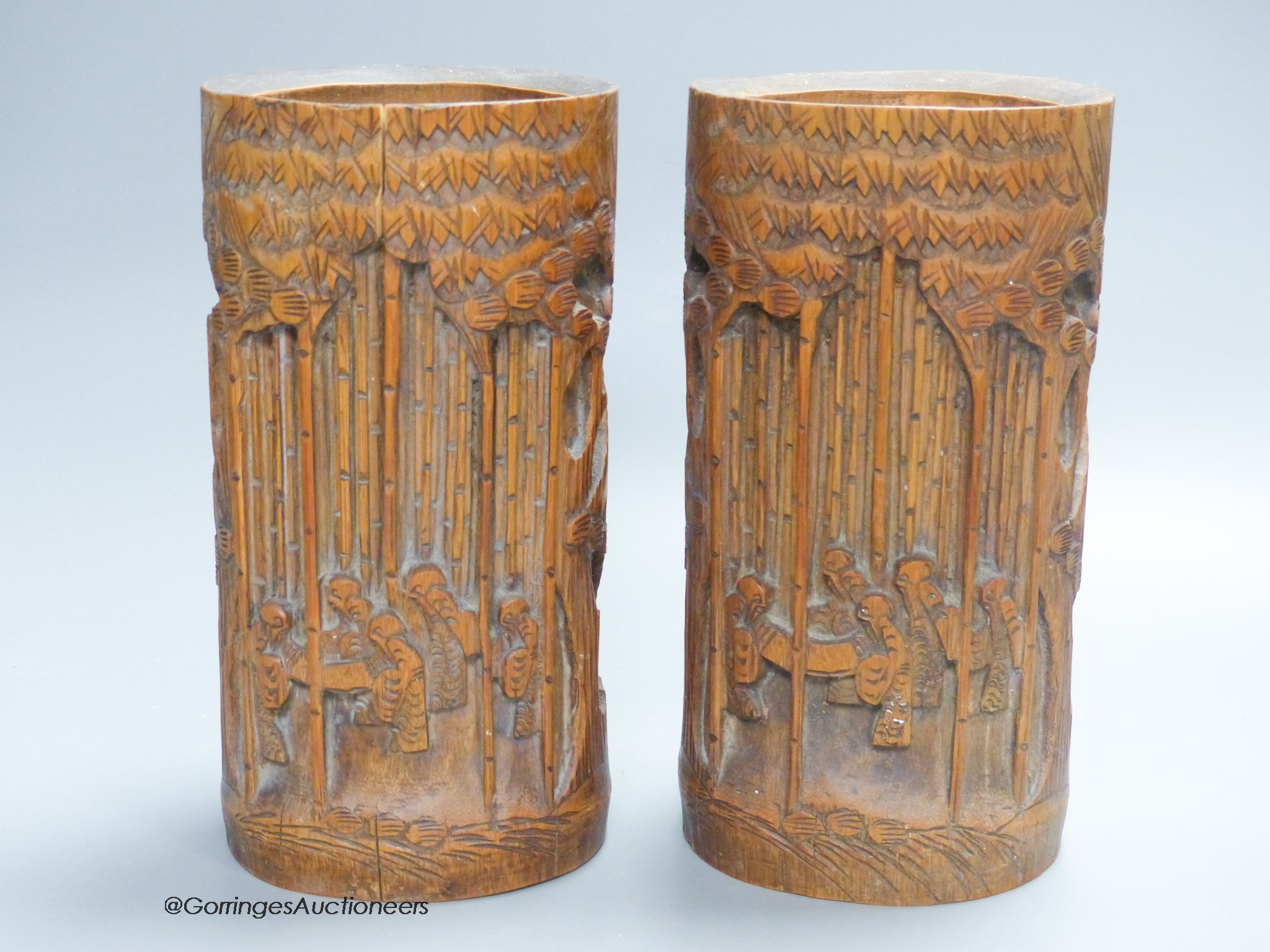 A pair of Chinese bamboo brush pots, carved with figures, signed to bases, height 21.5cm